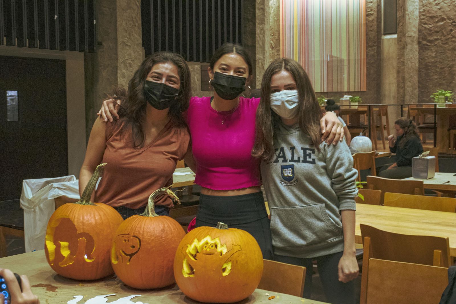 3 students with their 3 cool designs of carved pumpkins