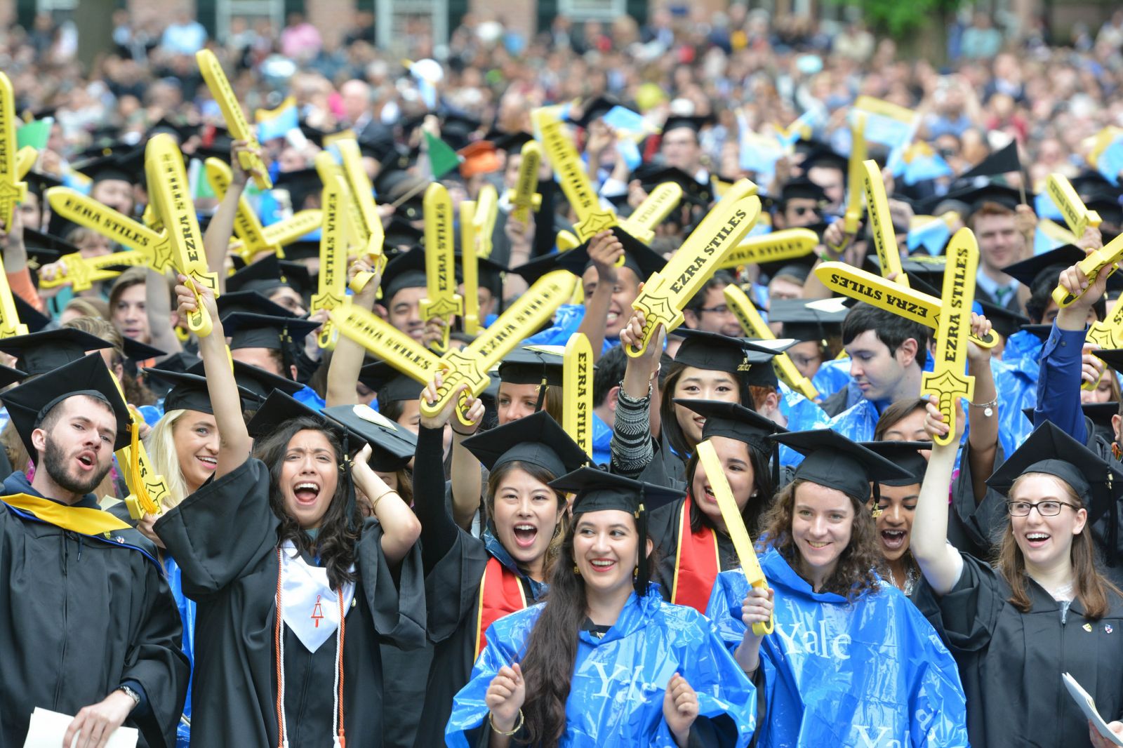 More students waving their Ezra Stiles swords despite the rainy weather
