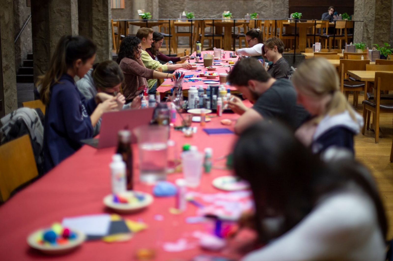 A long table full of Yale Students painting their rocks