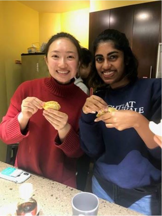 2 Yale students showing off their dumplings
