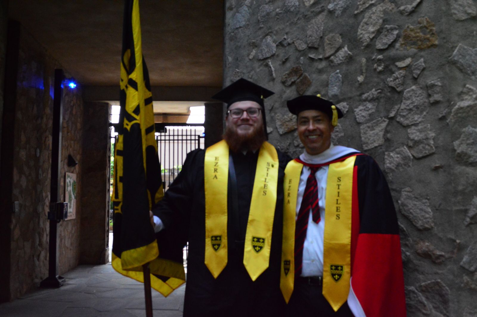 Commencement 2023 with a Stilesian valedictorian holding the college flag