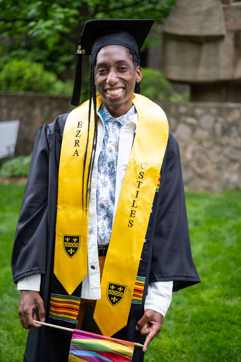 Graduating student with Ezra Stiles and National Society of Black Engineers stoles