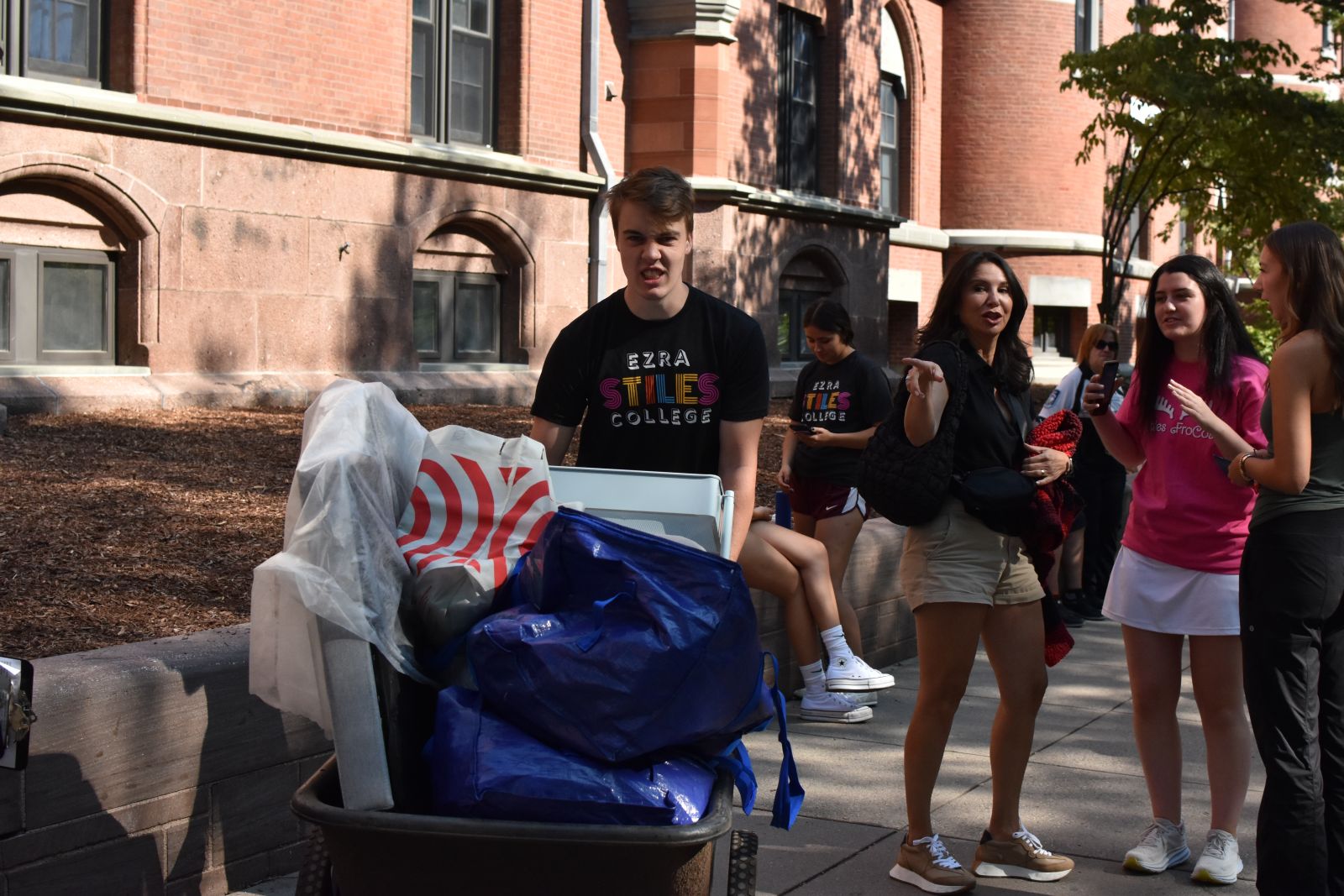 First-year student moves his belonging on a cart to his room at Ezra Stiles
