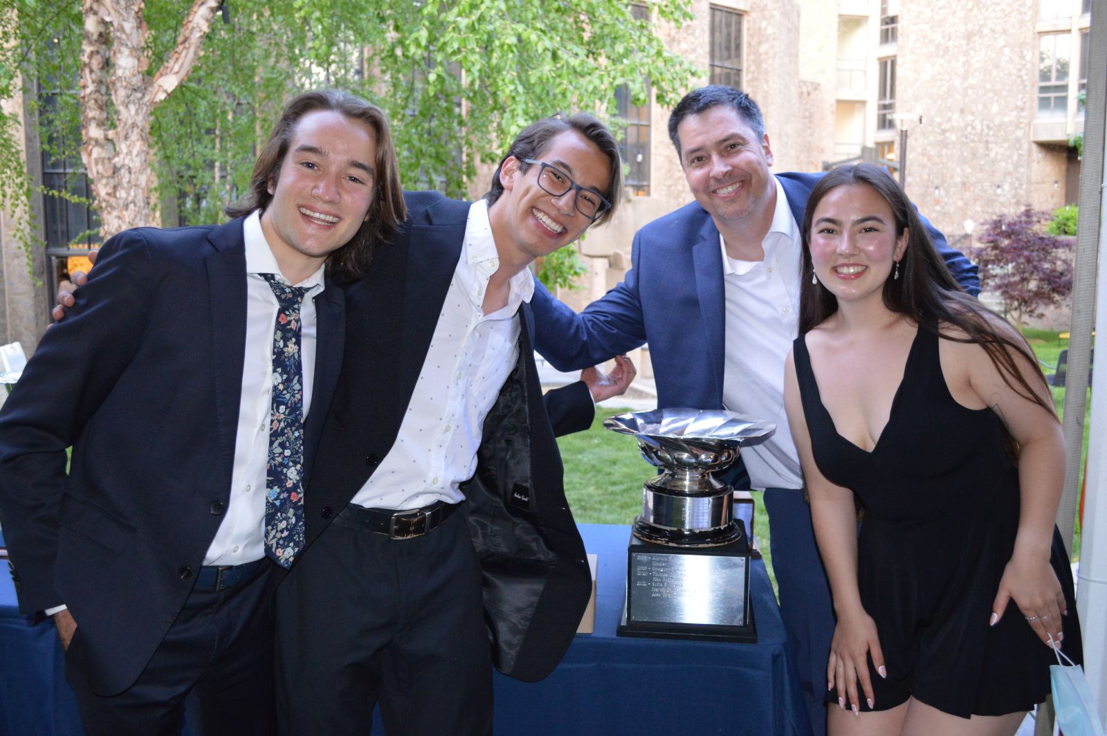 Students receiving a silver trophy as an award