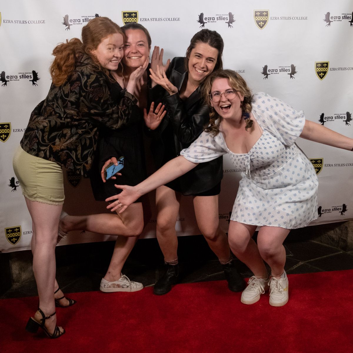 Group of 4 posing for the photo on the red carpet