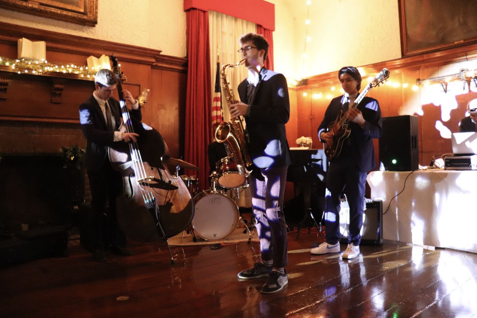 A jazz band playing the saxophone, violin, and guitar