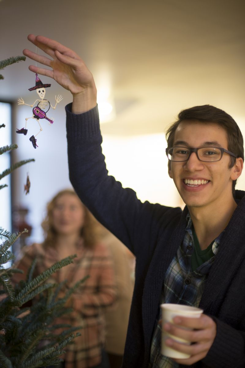 Students hanging ornaments on a Christmas tree