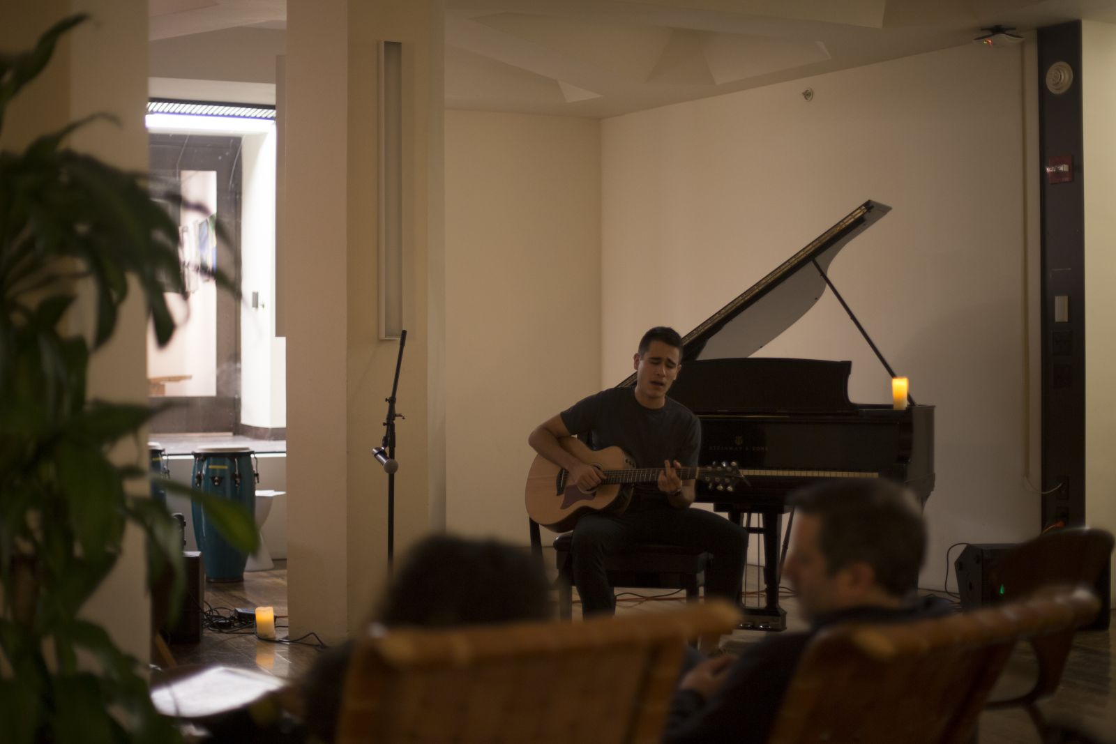 A guy playing the guitar during open-mic night