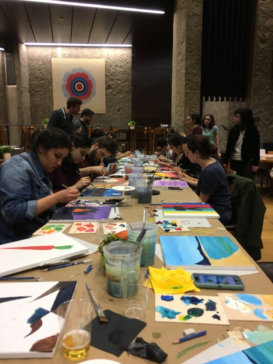 A bunch of students at a table painting