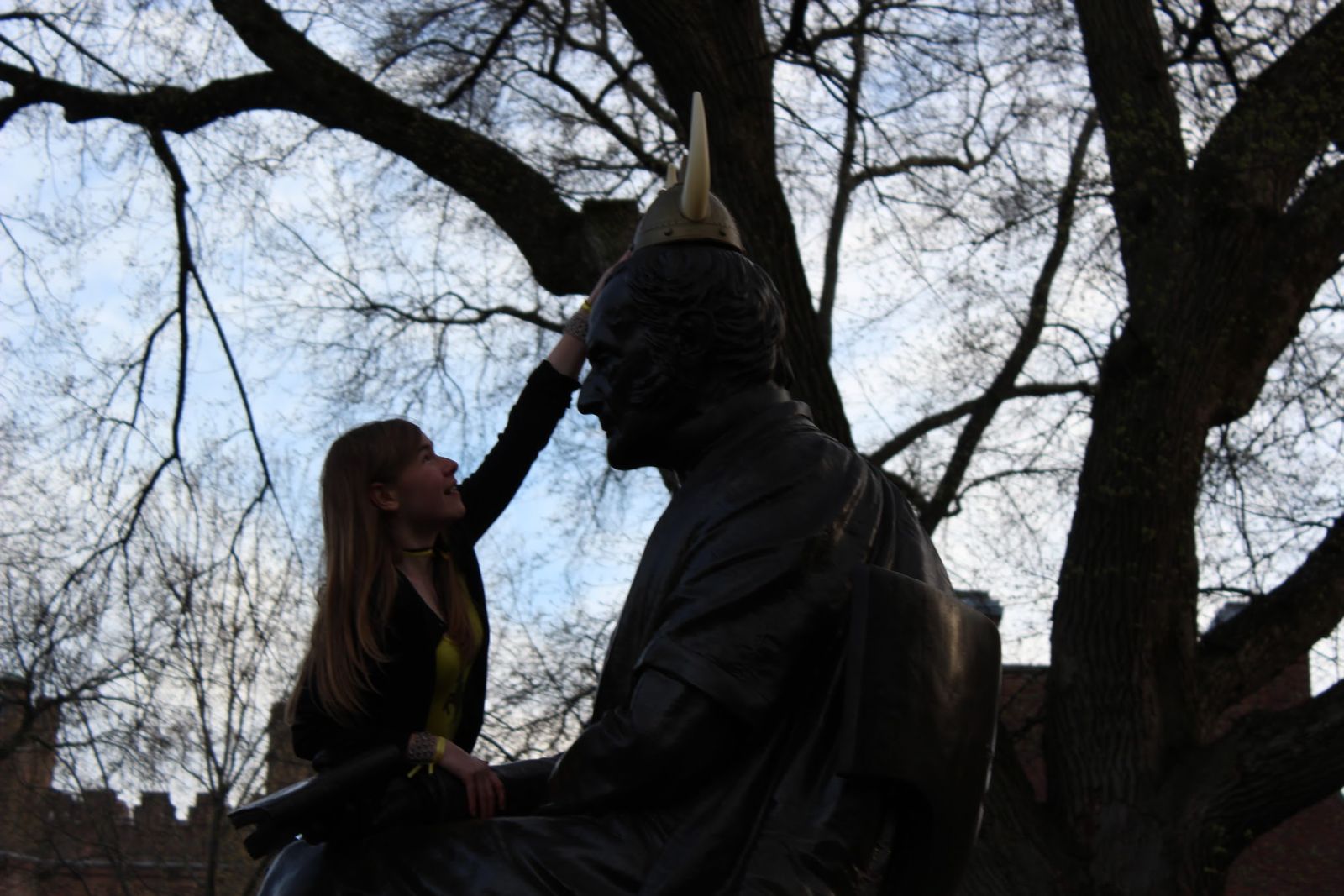girl next to statue