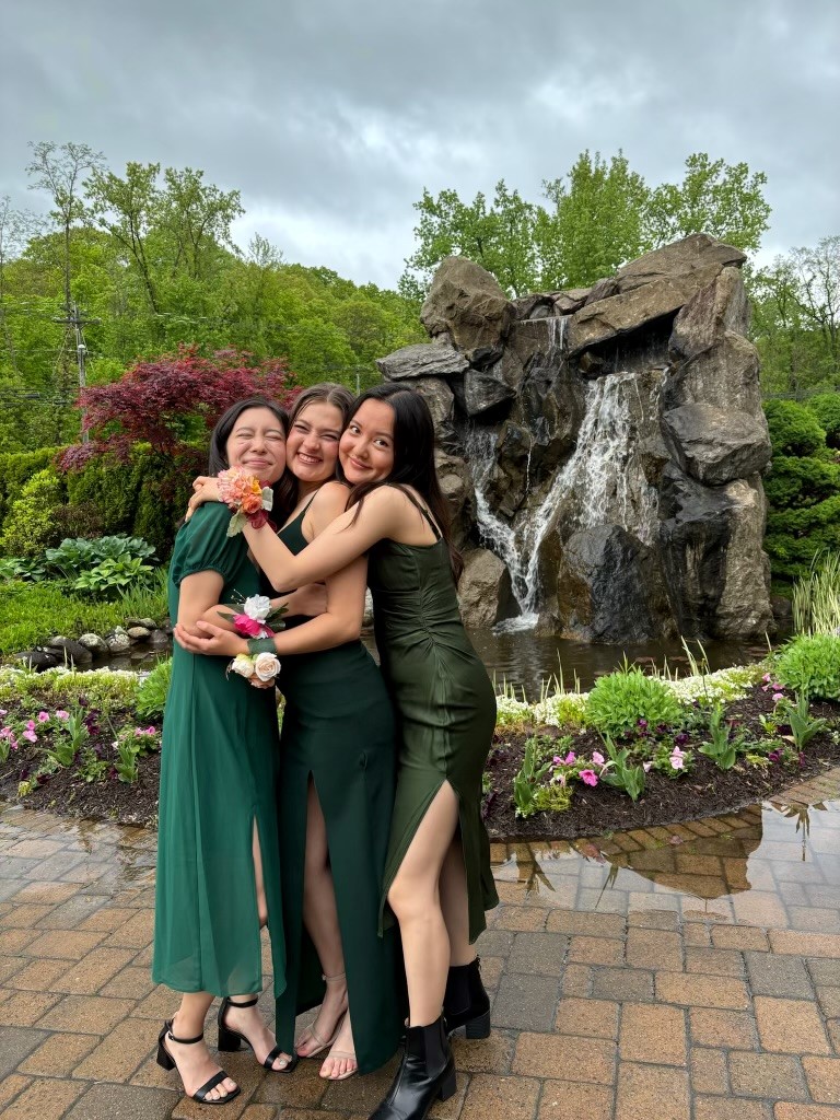 friends taking group picture for prom