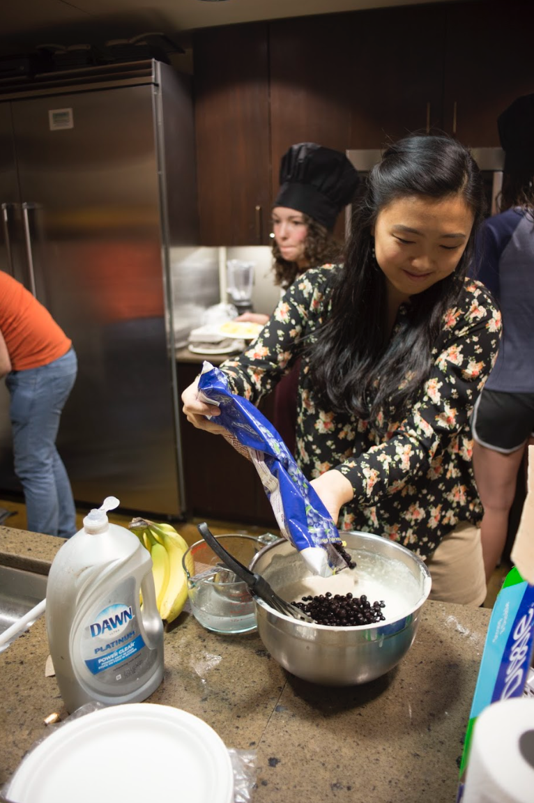 A SAC member dumps a bag of chocolate chips into a bowl