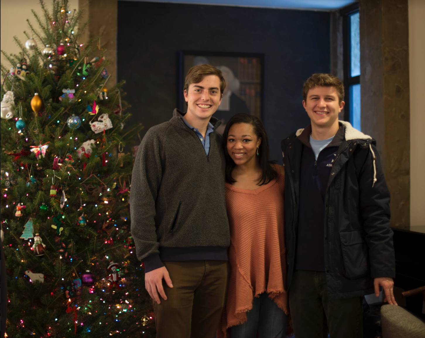 A group of students at Head Pitti's house next to the Christmas tree