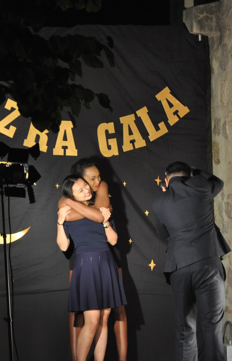 2 friends pose for the professional taking a photo