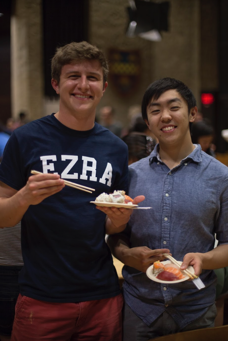 2 students with full plates of sushi