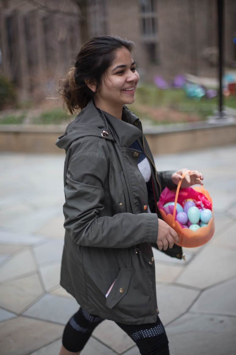A senior finds a basket full of easter eggs at the courtyard