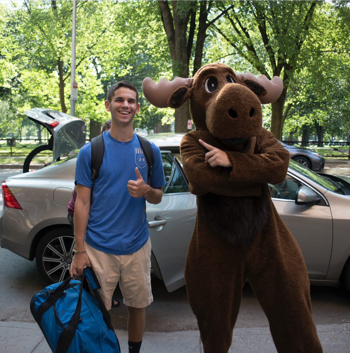 The moose mascot posing with the first-year moving in to Ezra Stiles