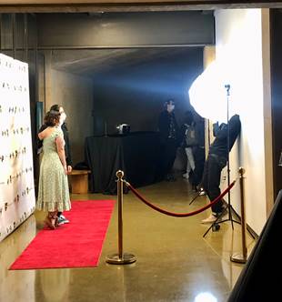 Students walking and taking photos on the red carpet