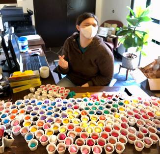 A yale student with a variety of play doh colors