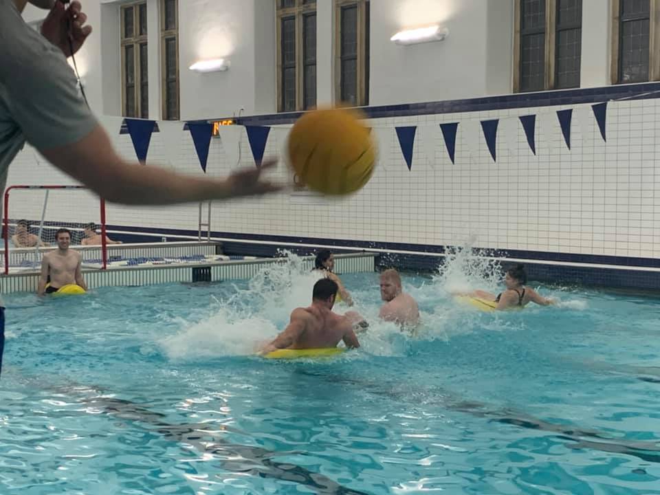 The water polo team competing in the pool
