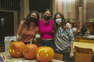 3 students with their 3 cool designs of carved pumpkins