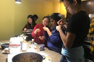 A bunch of students making dumplings