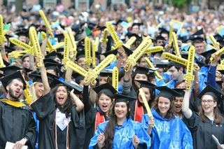 More students waving their Ezra Stiles swords despite the rainy weather