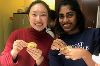2 Yale students showing off their dumplings