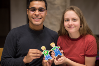 2 students show off their matching gingerbread cookies