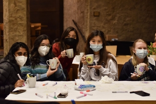 Yale students showcasing their painted mugs