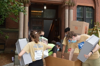 Fall move in volunteers classifying items during move in day