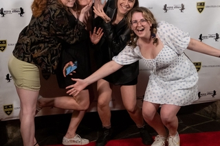 Group of 4 posing for the photo on the red carpet