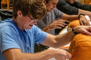 Pumpkin carving 3 guys