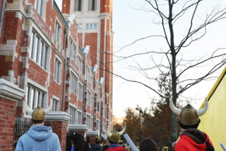 Students wearing viking helmets head on to raid another college