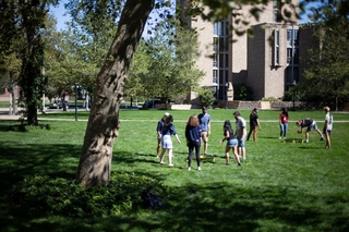 Moose playing spikeball on the Crescent Courtyard Lawn