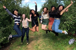 6 students in the air happy to be at the orchard