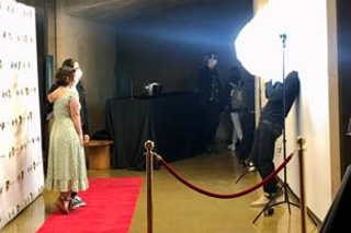Students walking and taking photos on the red carpet