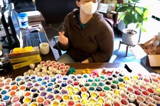 A yale student with a variety of play doh colors