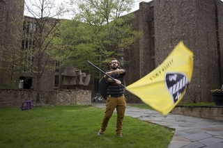 Yale Student spins around Ezra Stiles flag